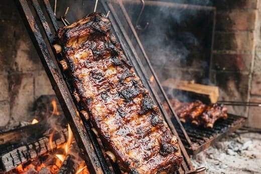 Glazed ribs roasting over a wood fire
